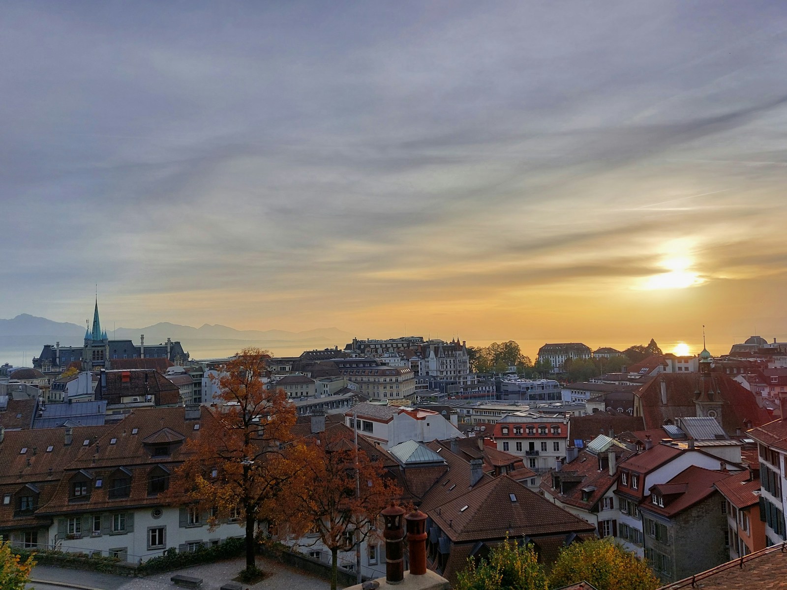a view of a city with a sunset in the background